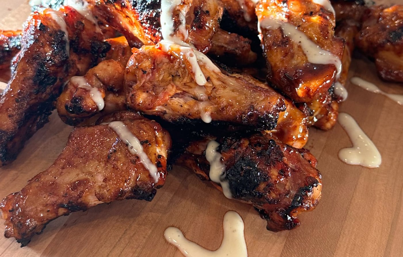 Finished serving of Meat Mitch Chicken Wings from the smoker, made with 3 of his best-selling sauces.